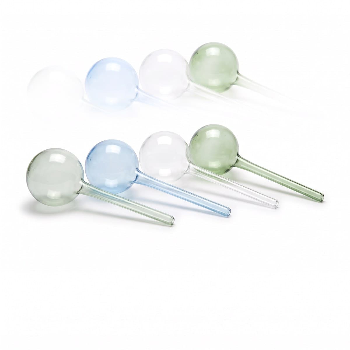 Four hand-blown glass watering globes with long stems in clear, blue and green tints